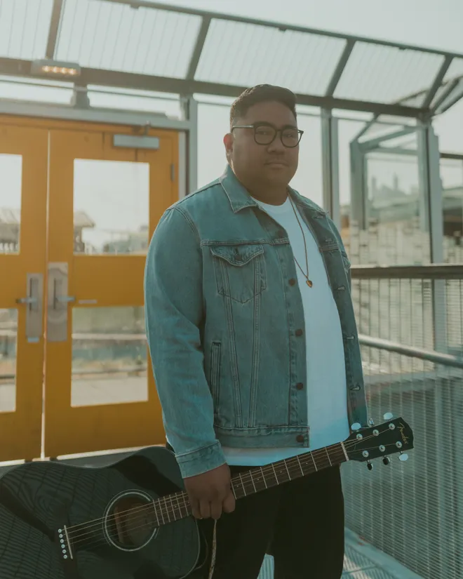 Matt Hermano on stage under warm lights